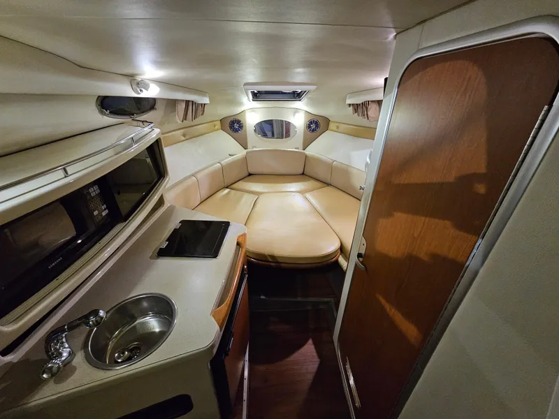 Slide: The Image of 2003 Chaparral 260 Signature Cruiser interior with kitchenette and seating area. - 3