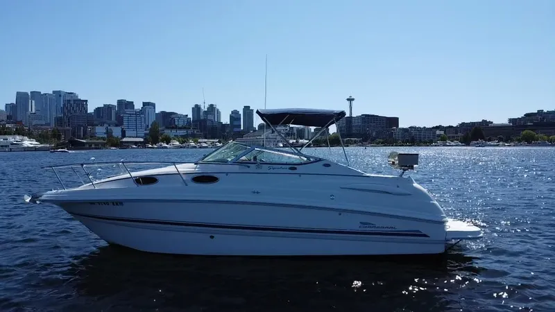 The Image of 2003 Chaparral 260 Signature Cruiser on water with city skyline in background. - 0