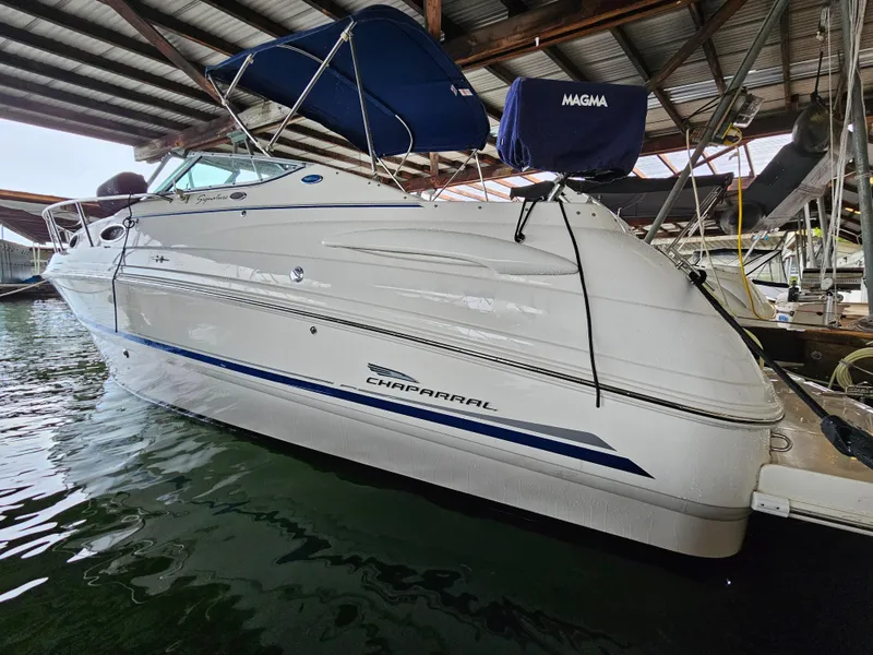 Slide: The Image of 2003 Chaparral 260 Signature Cruiser docked in a covered marina. - 12