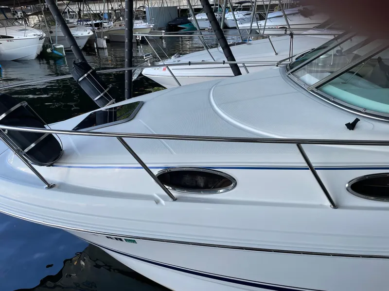 Slide: The Image of 2003 Chaparral 260 Signature Cruiser docked in a marina. - 13