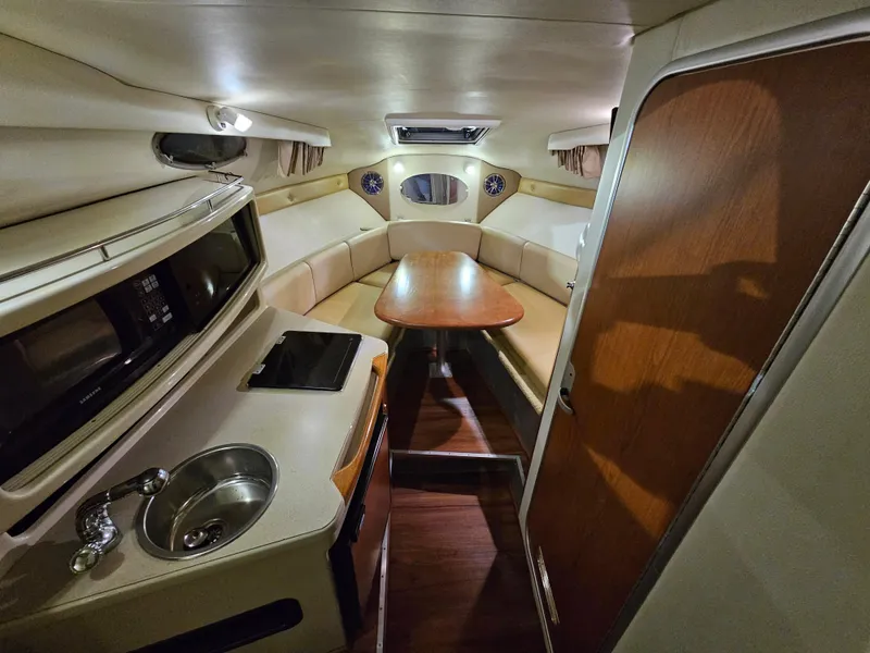 Slide: The Image of Interior of 2003 Chaparral 260 Signature Cruiser with kitchenette and seating area. - 2