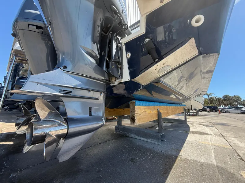 Slide: The Image of 2020 Jeanneau Leader 9.0 WA boat on dry dock, showcasing dual outboard motors. - 14