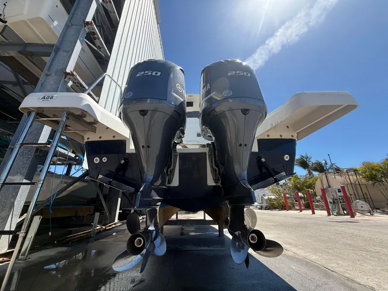Slide: The Image of 2020 Jeanneau Leader 9.0 WA with dual 250 horsepower outboard engines, docked under clear skies. - 16