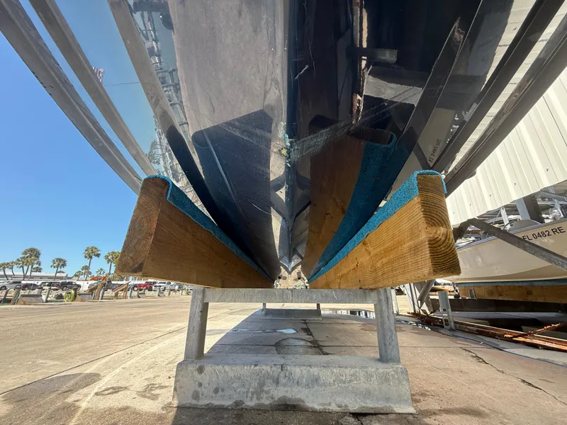Slide: The Image of 2020 Jeanneau Leader 9.0 WA boat hull on a support stand, viewed from below. - 23