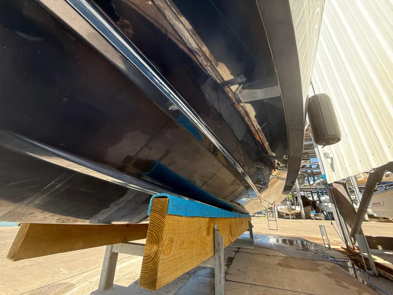 Slide: The Image of 2020 Jeanneau Leader 9.0 WA boat hull on dry dock, side view. - 28