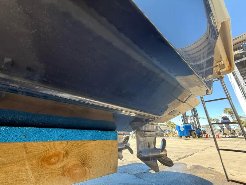 Slide: The Image of 2020 Jeanneau Leader 9.0 WA boat hull on dry dock, showing propellers and support blocks. - 30