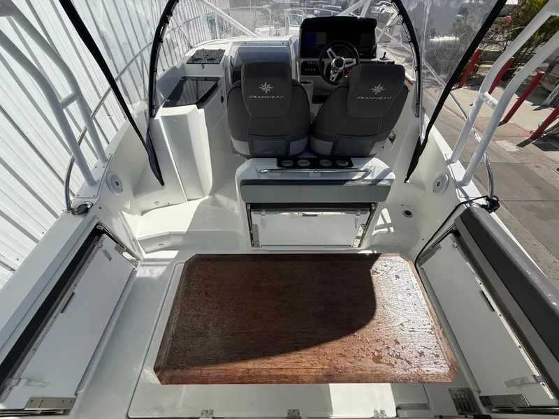 Slide: The Image of 2020 Jeanneau Leader 9.0 WA boat interior with helm, seating, and wooden deck. - 34