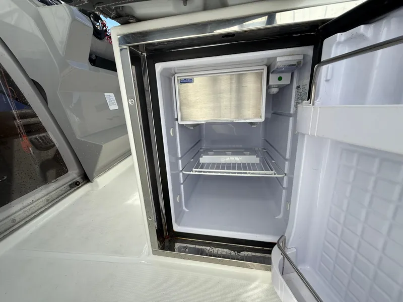 Slide: The Image of Open refrigerator on 2020 Jeanneau Leader 9.0 WA boat, showcasing interior storage space. - 40