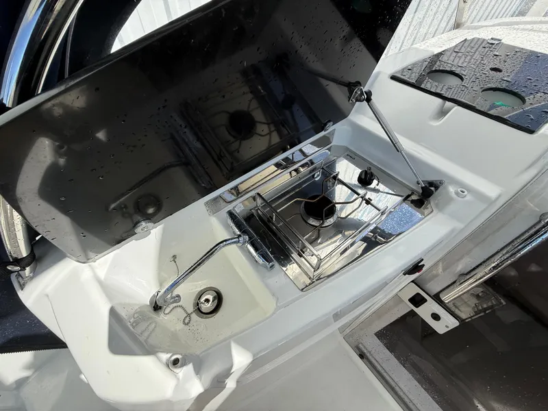 Slide: The Image of Outdoor kitchen area on a 2020 Jeanneau Leader 9.0 WA boat, featuring a compact stove. - 42