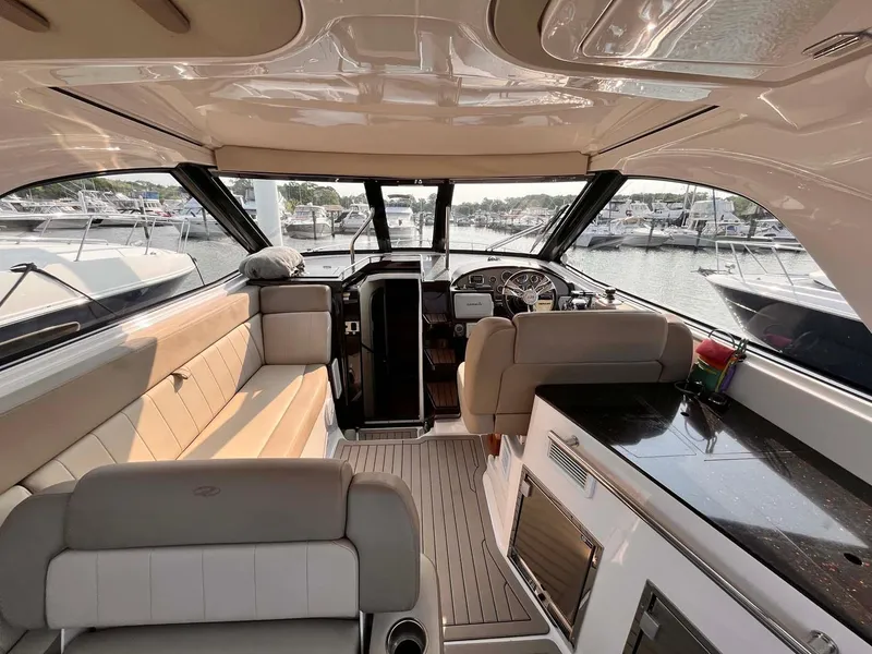 Slide: The Image of Interior of a 2014 Regal 35 Sport Coupe yacht, featuring luxurious seating and modern amenities. - 19