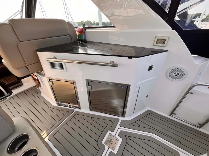 Slide: The Image of 2014 Regal 35 Sport Coupe interior with sleek kitchenette and modern design. - 22