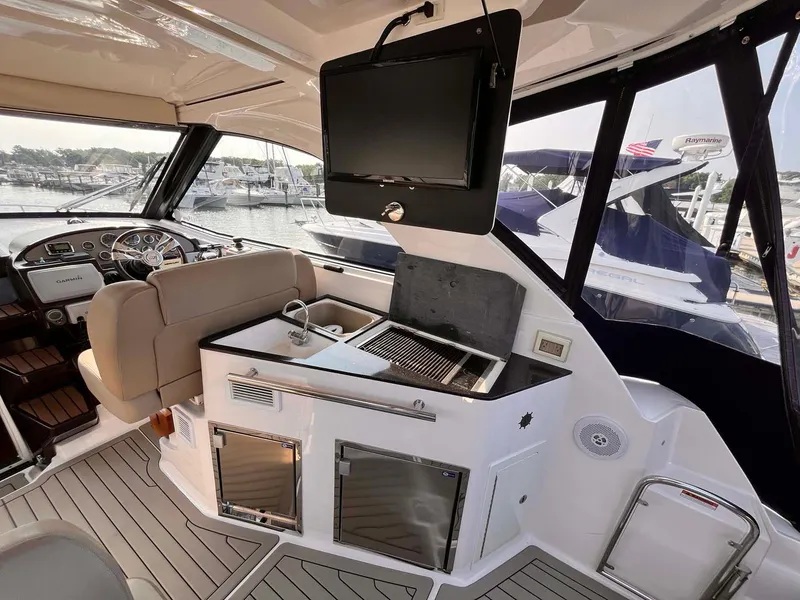 Slide: The Image of 2014 Regal 35 Sport Coupe interior with helm, seating, and entertainment area. - 25