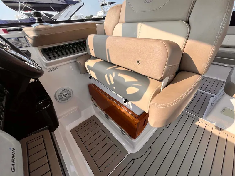 Slide: The Image of 2014 Regal 35 Sport Coupe interior with beige seating and Garmin equipment. - 28