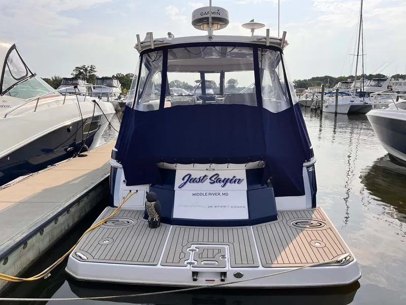 Slide: The Image of 2014 Regal 35 Sport Coupe docked at marina, rear view with blue cover. - 3