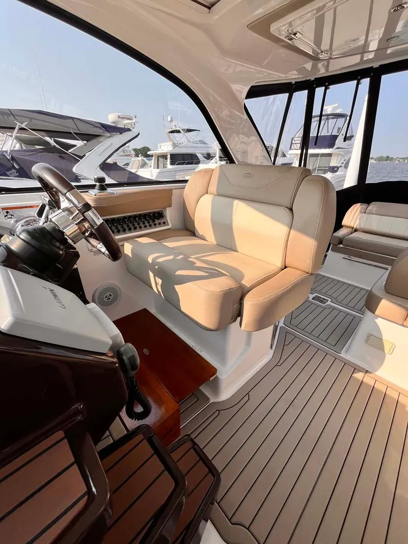 Slide: The Image of 2014 Regal 35 Sport Coupe interior with beige seating and modern helm. - 30