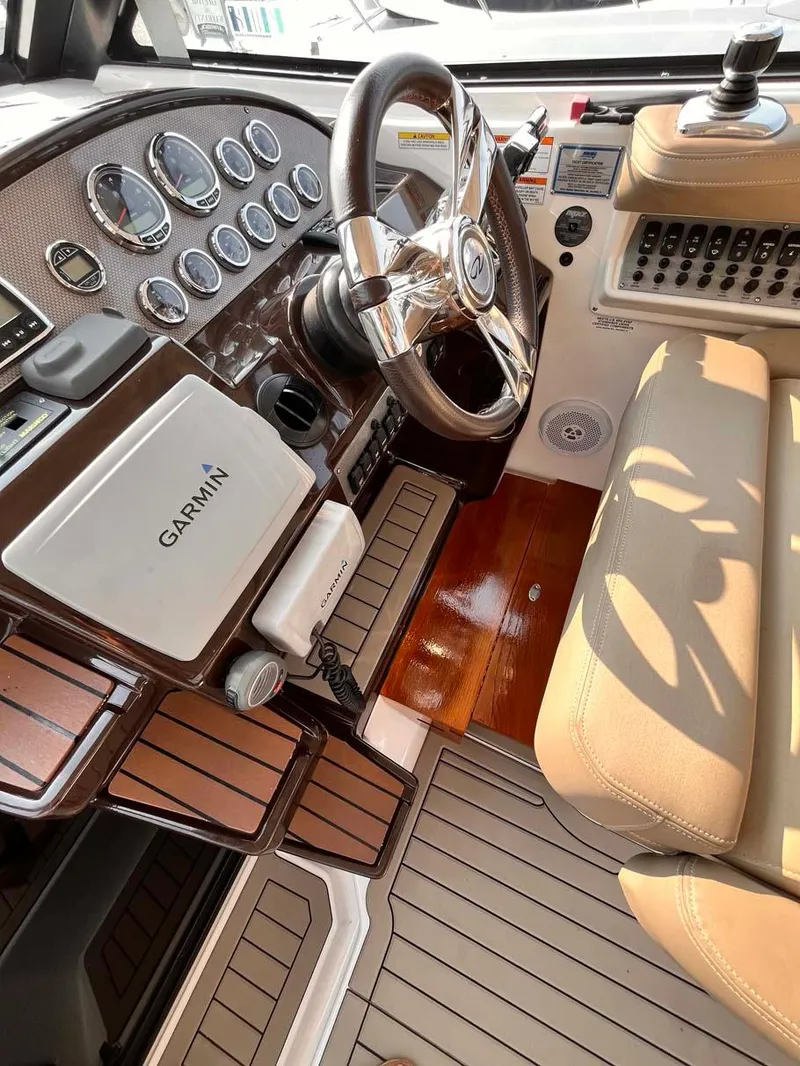 Slide: The Image of 2014 Regal 35 Sport Coupe cockpit with Garmin navigation, luxurious seating, and modern controls. - 31