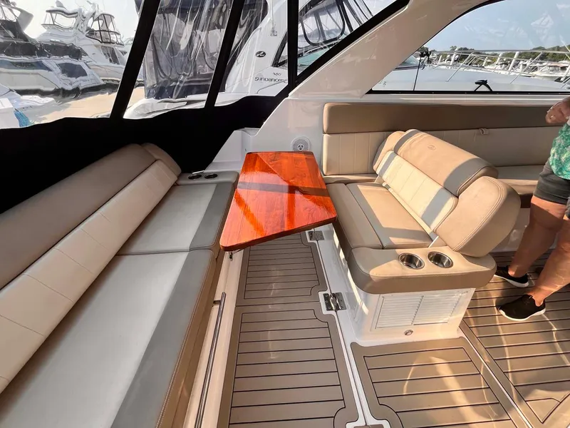Slide: The Image of 2014 Regal 35 Sport Coupe interior with beige seating and wooden table. - 32