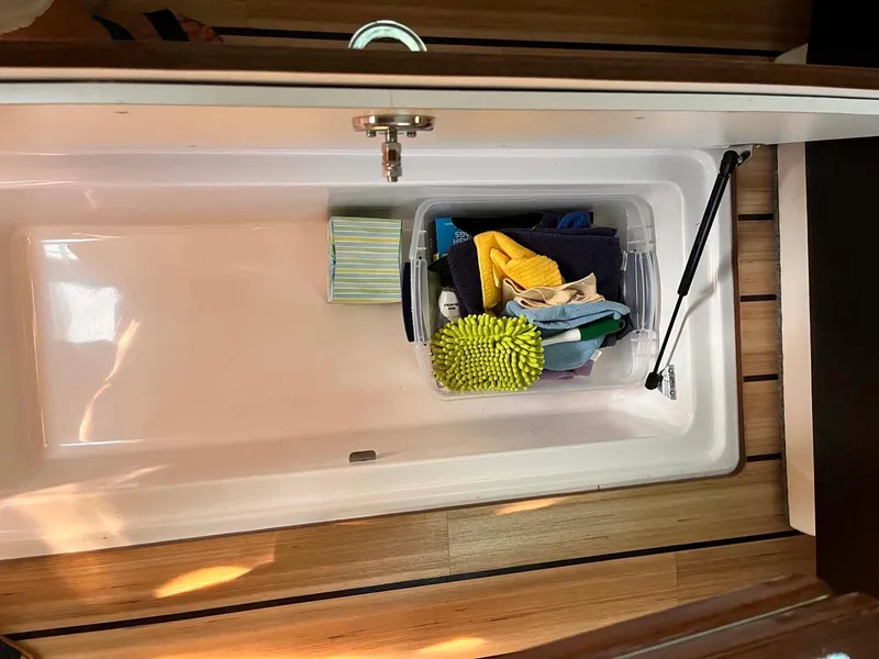 Slide: The Image of Storage compartment in 2014 Regal 35 Sport Coupe with cleaning supplies. - 33