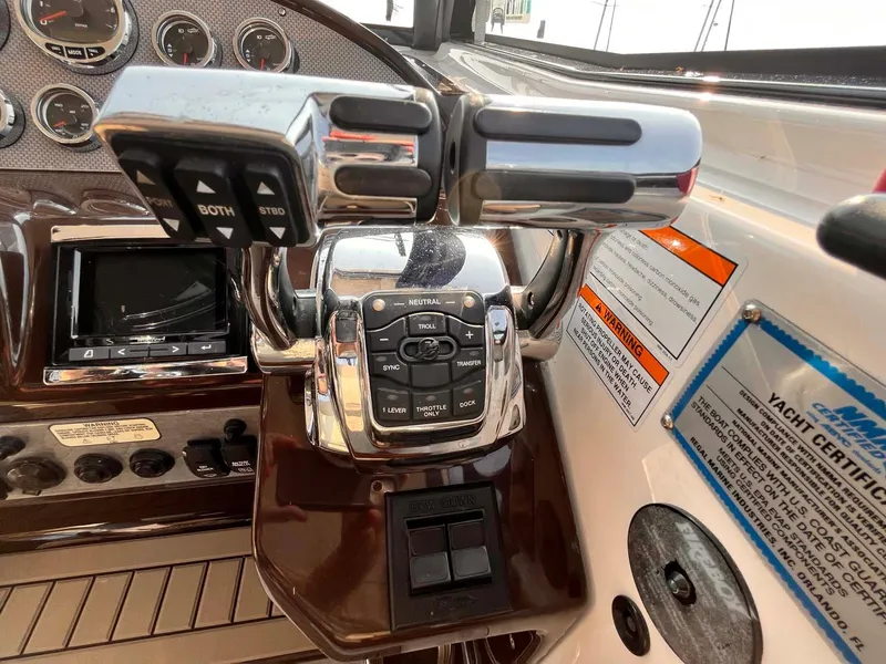 Slide: The Image of Control panel of a 2014 Regal 35 Sport Coupe yacht with throttle and navigation controls. - 35