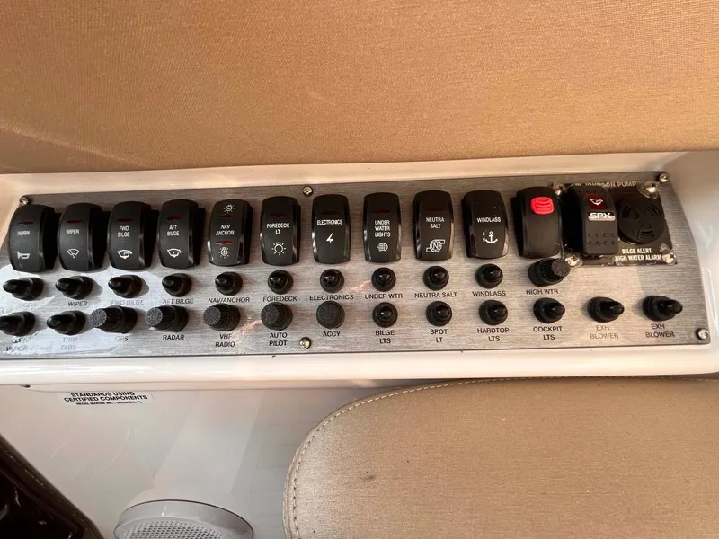 Slide: The Image of Control panel of a 2014 Regal 35 Sport Coupe boat with various switches and dials. - 36