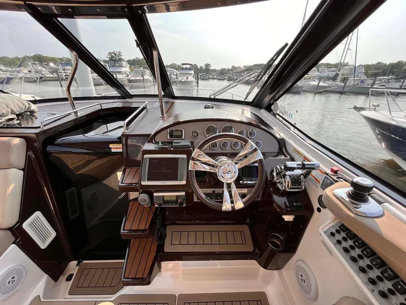Slide: The Image of 2014 Regal 35 Sport Coupe helm with modern controls and marina view. - 37