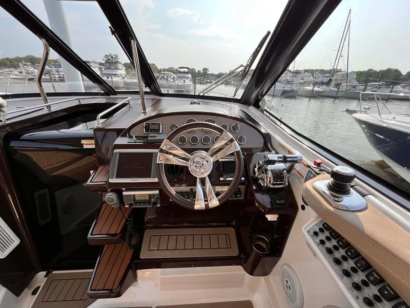Slide: The Image of 2014 Regal 35 Sport Coupe helm with modern controls and marina view. - 39