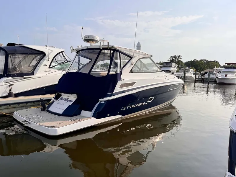 Slide: The Image of 2014 Regal 35 Sport Coupe yacht docked in a marina, side view. - 4