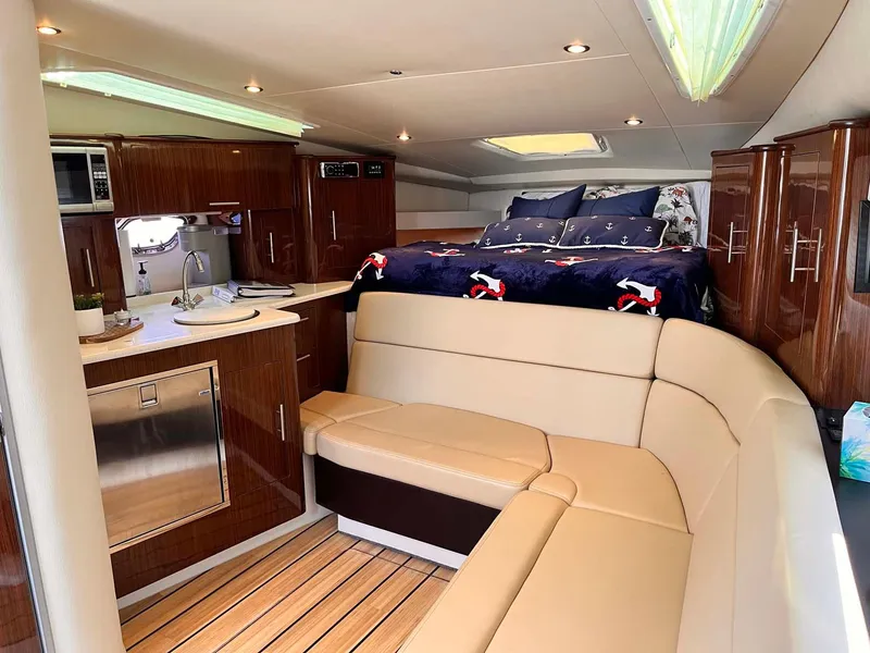 Slide: The Image of Interior of 2014 Regal 35 Sport Coupe with kitchen, seating, and bed. - 43