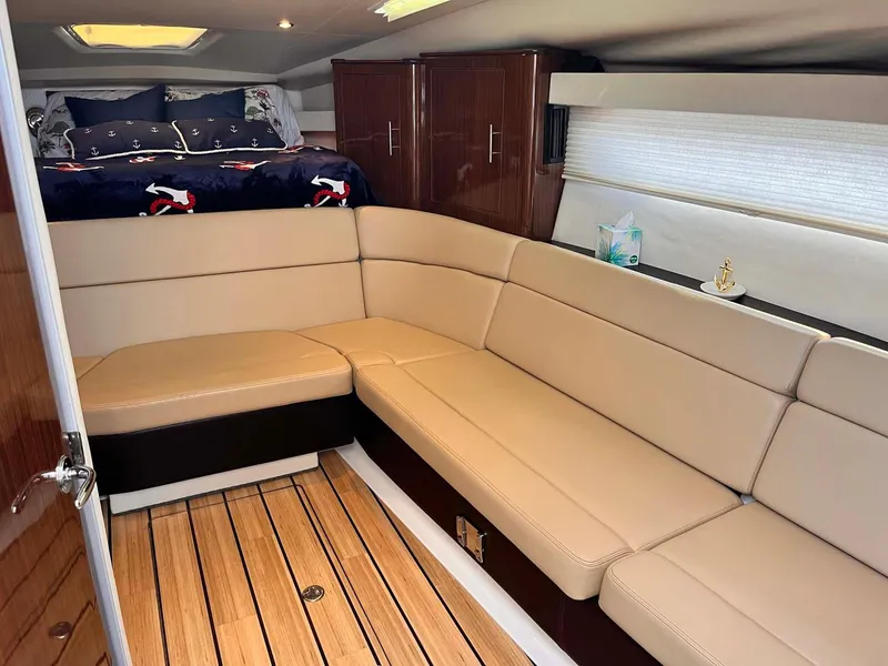 Slide: The Image of Interior of 2014 Regal 35 Sport Coupe with beige seating and wooden flooring. - 44