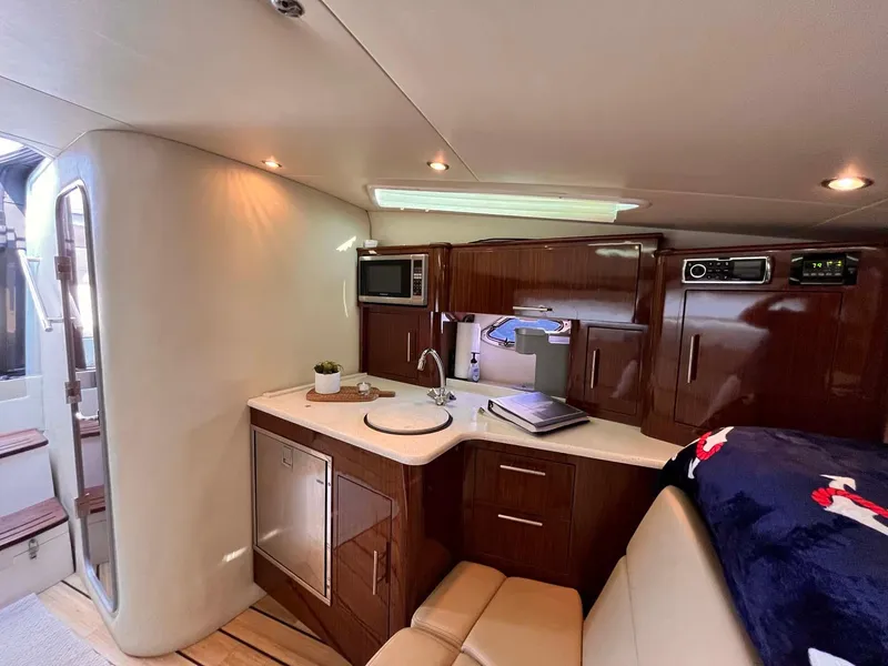 Slide: The Image of Luxurious interior of 2014 Regal 35 Sport Coupe with modern kitchenette and seating area. - 46
