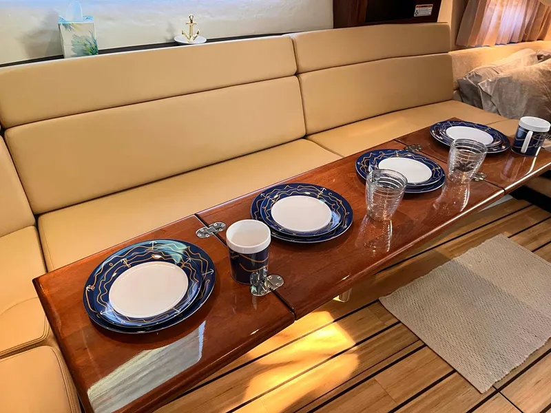 Slide: The Image of Luxurious interior of 2014 Regal 35 Sport Coupe with elegant dining setup. - 48
