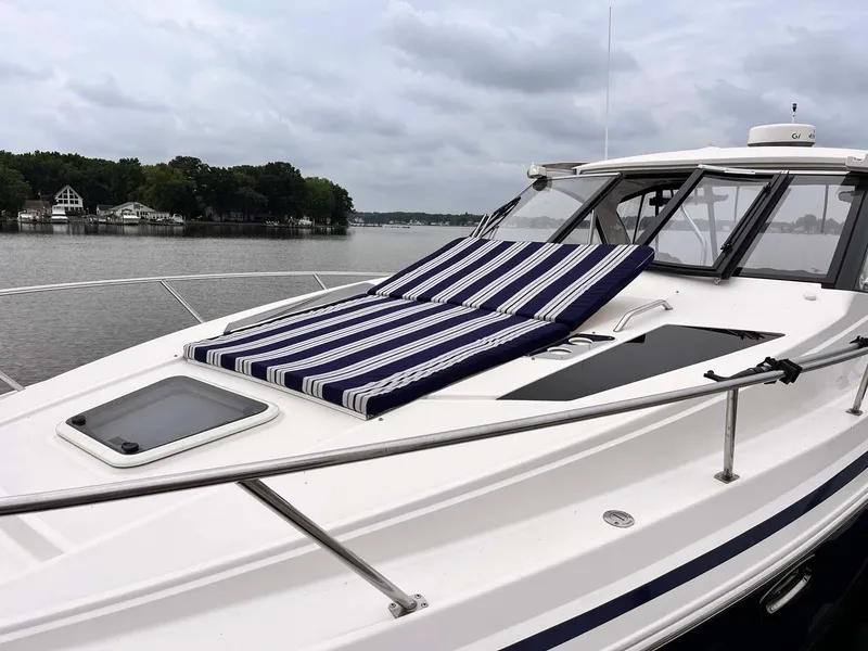 Slide: The Image of 2014 Regal 35 Sport Coupe on a lake with striped sun loungers. - 7