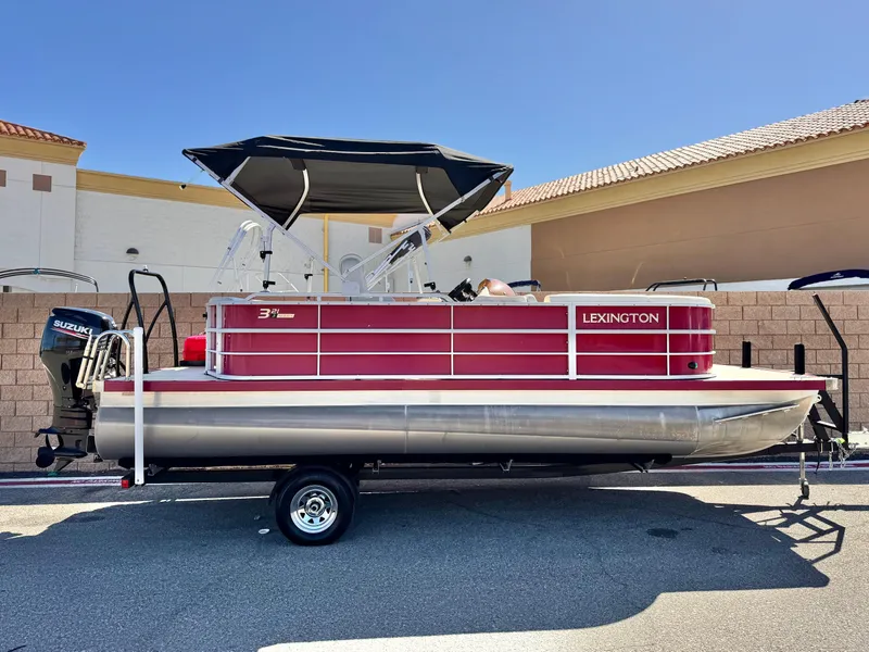 The Image of 2023 Lexington 321 CRUISE pontoon boat with canopy, parked on trailer. - 0