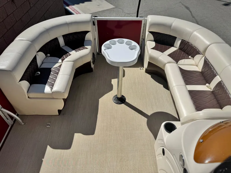 Slide: The Image of 2023 Lexington 321 CRUISE boat interior with curved seating and a central table. - 11