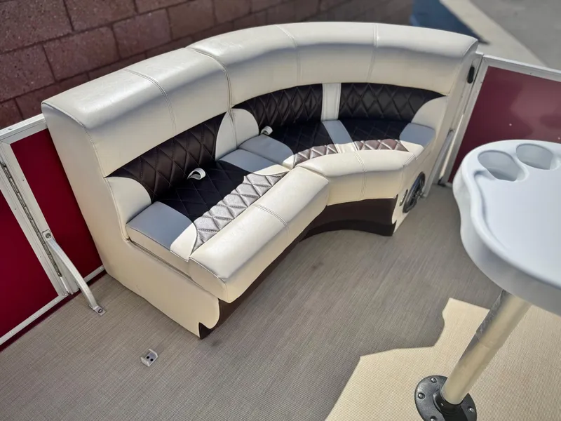 Slide: The Image of 2023 Lexington 321 CRUISE boat interior with plush seating and cup holders. - 12