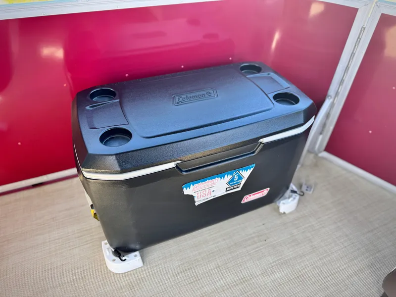 Slide: The Image of Cooler inside 2023 Lexington 321 CRUISE boat, featuring cup holders and a red interior panel. - 17