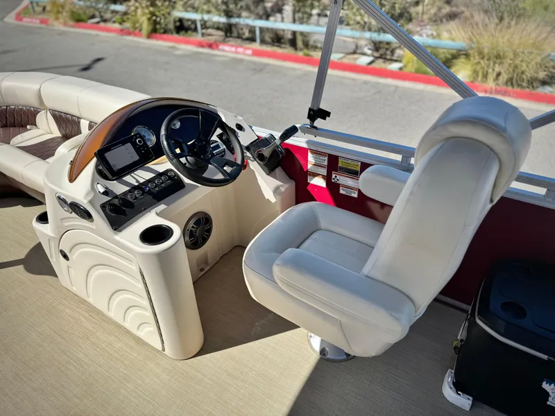 Slide: The Image of 2023 Lexington 321 CRUISE boat interior with steering console and seating. - 18