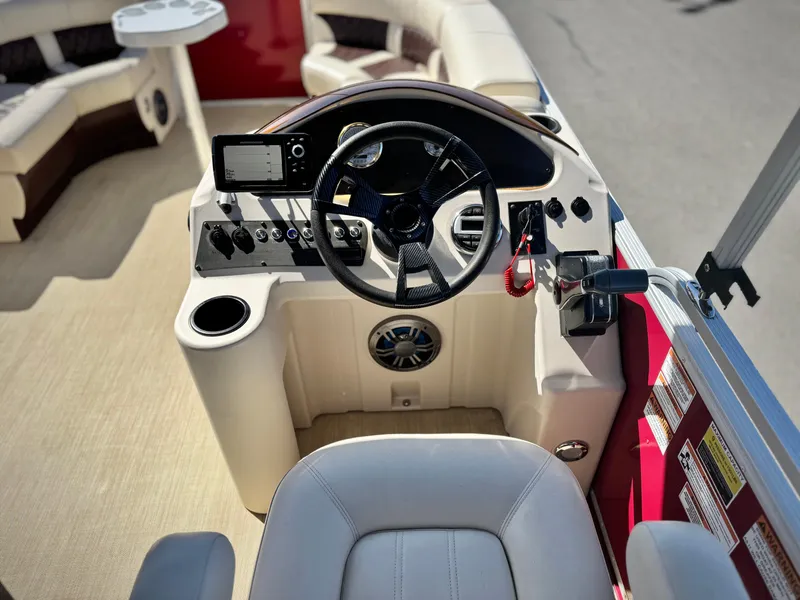 Slide: The Image of 2023 Lexington 321 CRUISE boat interior with steering wheel and control panel. - 19