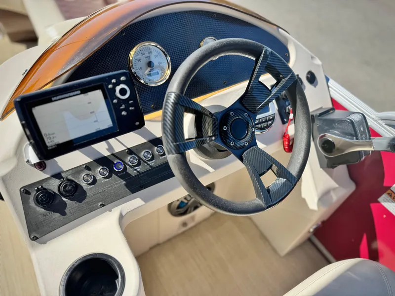 Slide: The Image of 2023 Lexington 321 CRUISE boat dashboard with steering wheel and navigation system. - 20