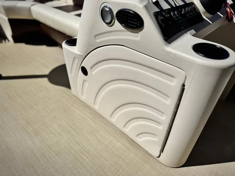 Slide: The Image of 2023 Lexington 321 CRUISE boat console with cup holders and control panel. - 22