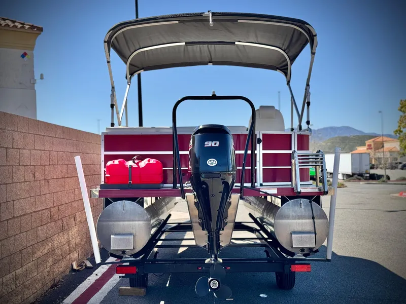 Slide: The Image of 2023 Lexington 321 CRUISE pontoon boat with canopy and outboard motor in parking lot. - 5
