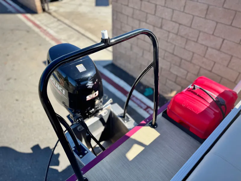 Slide: The Image of 2023 Lexington 321 CRUISE boat with motor and red bag on deck. - 8