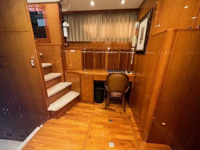 Slide: The Image of Luxurious interior of 2000 Jefferson Marquessa 60 MY yacht with wooden finishes and cozy workspace. - 14