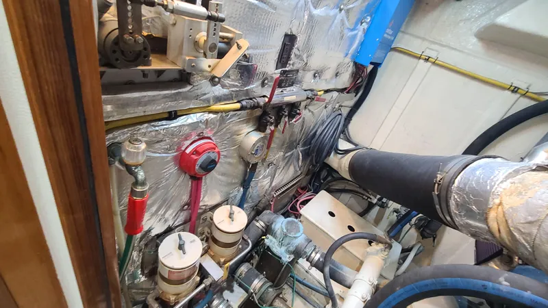 Slide: The Image of Engine room of a 2000 Jefferson Marquessa 60 MY yacht, showcasing mechanical components and wiring. - 22