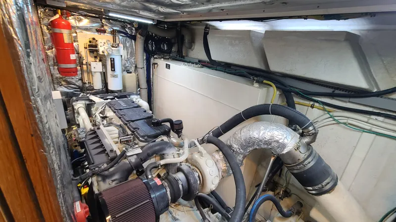 Slide: The Image of Engine room of a 2000 Jefferson Marquessa 60 MY yacht, featuring mechanical components and fire extinguisher. - 23