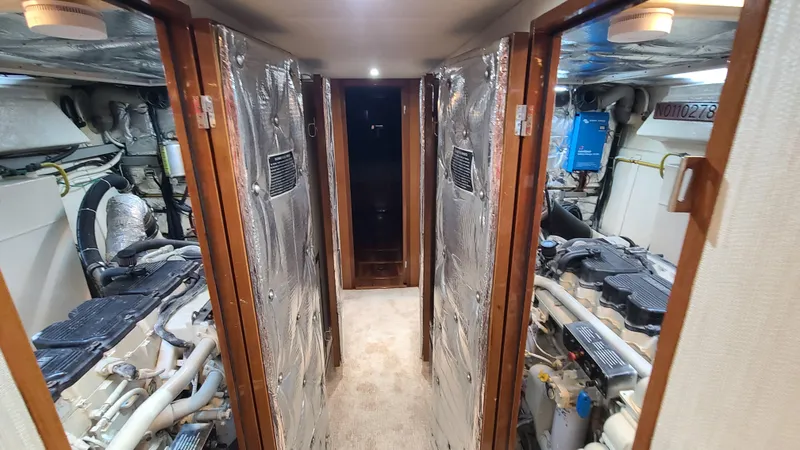 Slide: The Image of Engine room of 2000 Jefferson Marquessa 60 MY yacht, featuring dual engines and metallic insulation. - 24