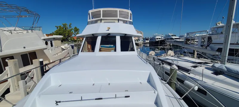 Slide: The Image of Front view of a 2000 Jefferson Marquessa 60 MY yacht docked at a marina. - 25