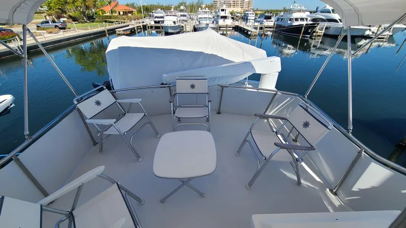 Slide: The Image of Deck seating area on a 2000 Jefferson Marquessa 60 MY yacht at a marina. - 27