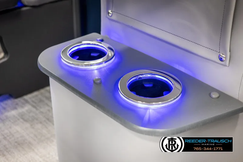 Slide: The Image of Illuminated cup holders on 2025 Avalon LSZ Entertainer boat, featuring blue LED lighting. - 38