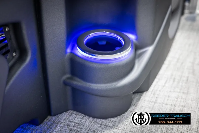 Slide: The Image of Illuminated cup holder on 2025 Avalon LSZ Entertainer boat, featuring blue LED lighting. - 43